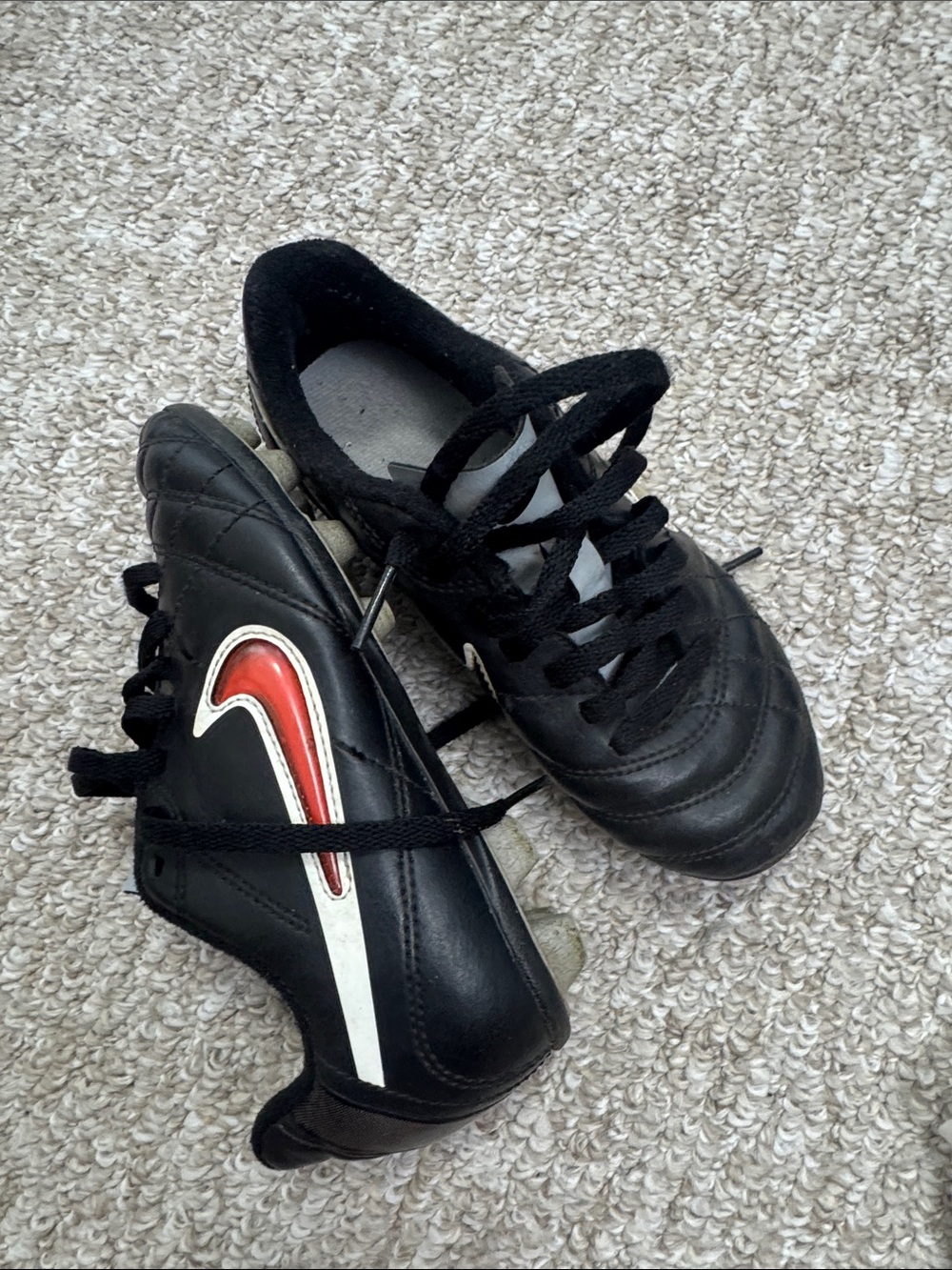 Nike Kids Black Soccer Cleats with Red and White Swoosh